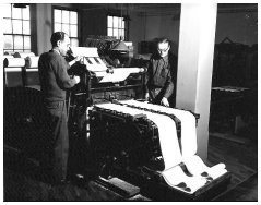 The perforator operator is Louis Esposito. The onlooker appears to be John Sonnentag - click here to view enlarged photograph